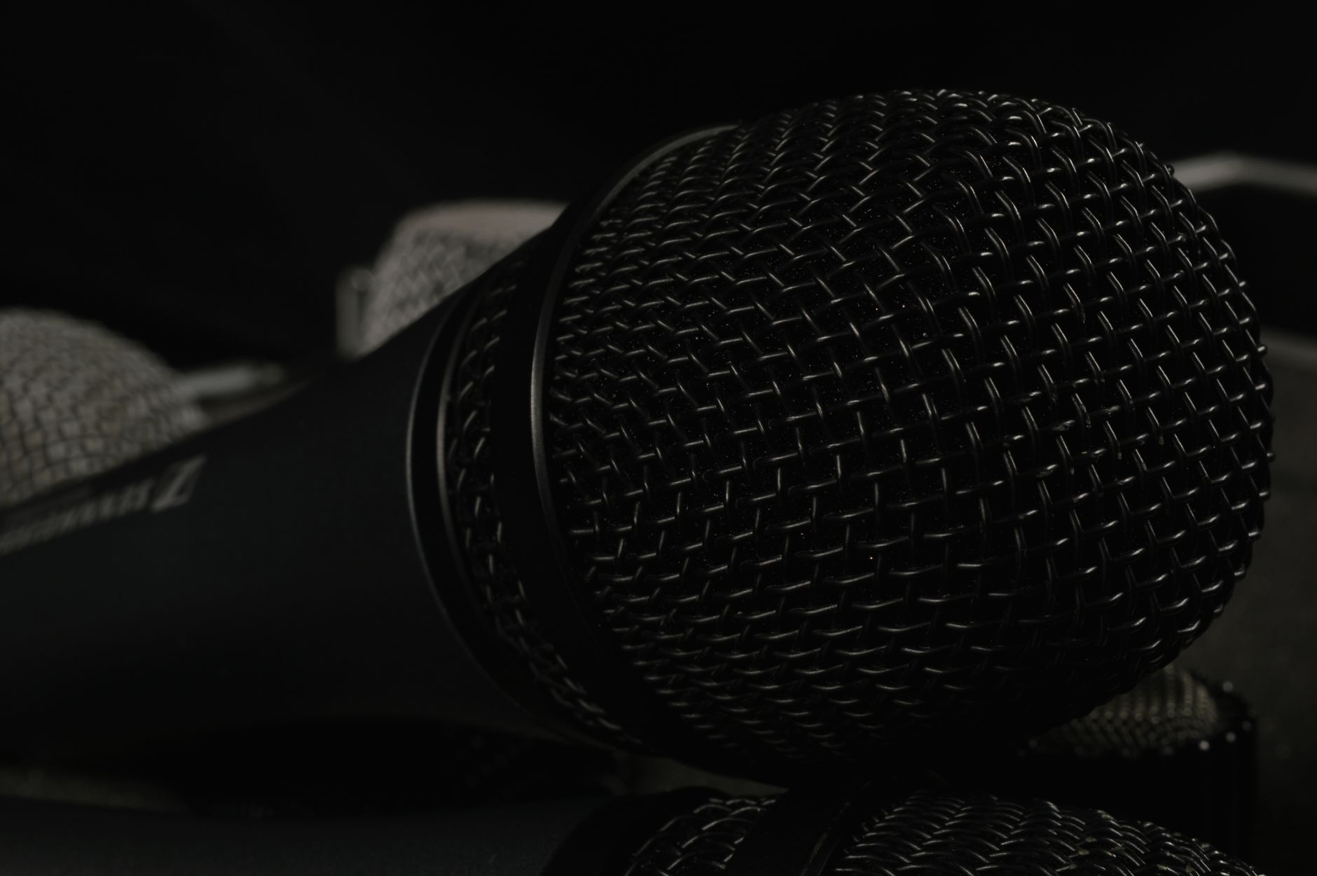 Micro Có Dây Bị Đứt Tiếng, Chập Chờn - A detailed close-up of professional microphones featuring windscreens, ideal for tech and audio themes.