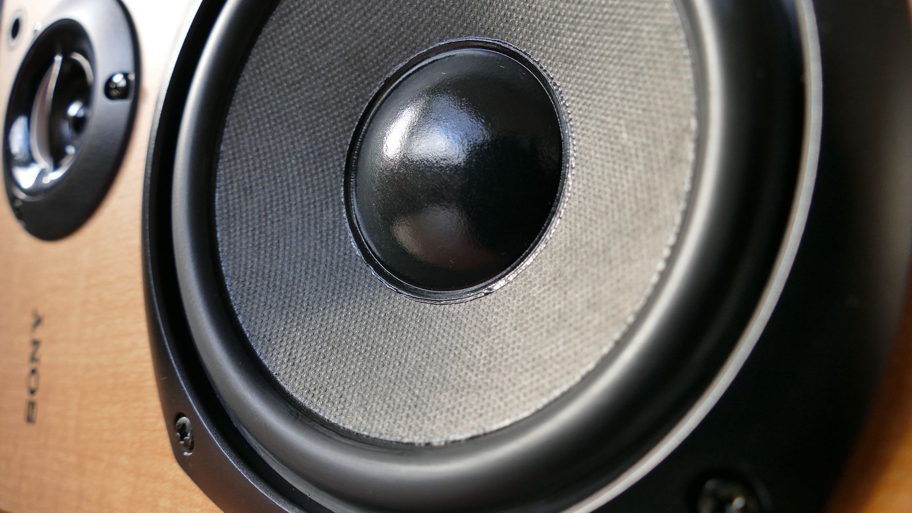 Thay Màng Loa, Ép Màng Loa – Quy Trình & Chi Phí - Detailed close-up of a modern speaker woofer cone showing texture and design.