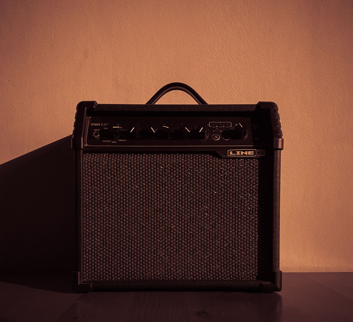 Hướng Dẫn Phối Ghép Amply Với Loa Đúng Trở Kháng - Minimalist image of a compact audio amplifier with control dials.