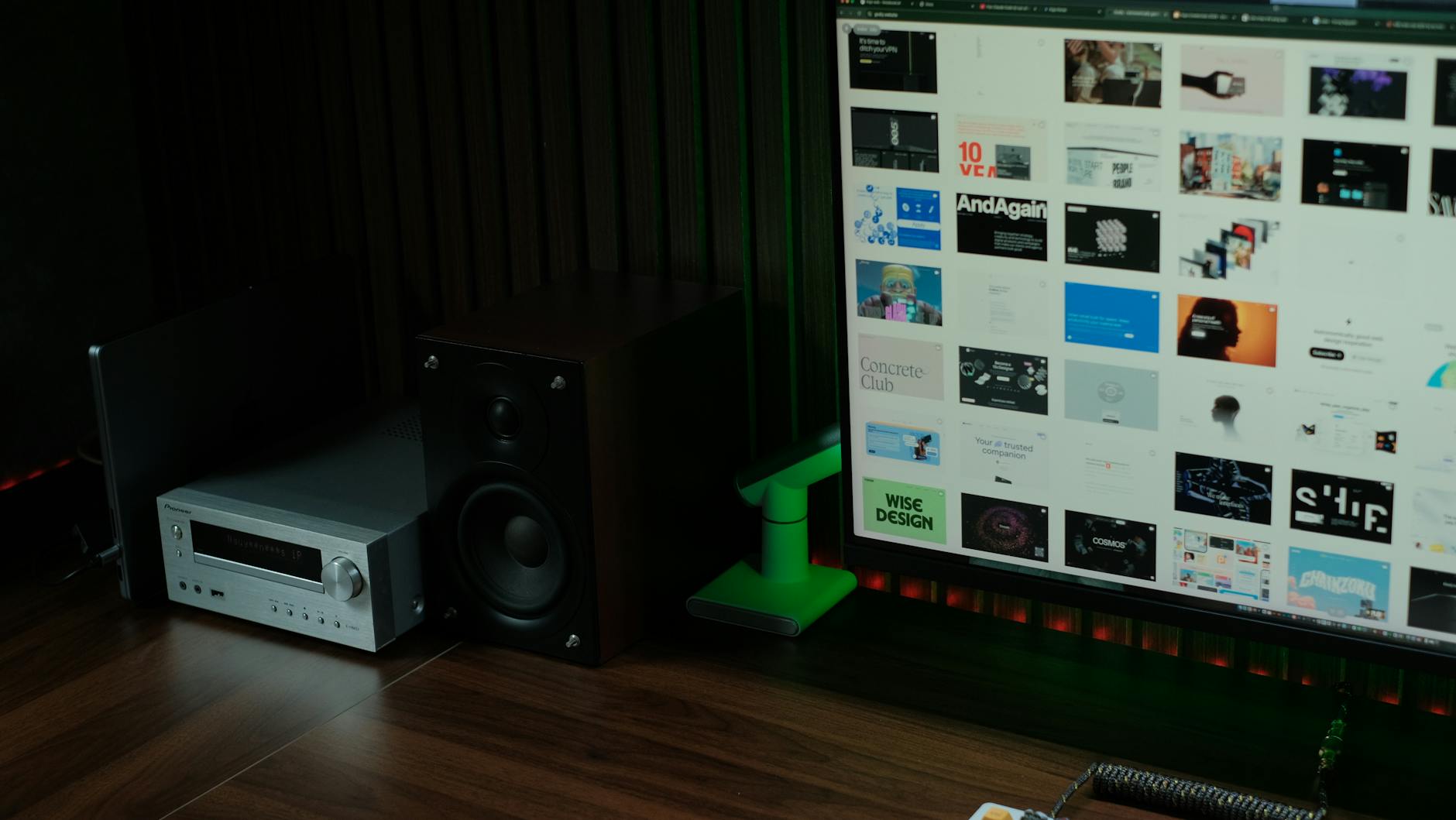 cách treo loa lên tường đúng kỹ thuật - Stylish home office with computer, speaker, and audio receiver for creative design work.