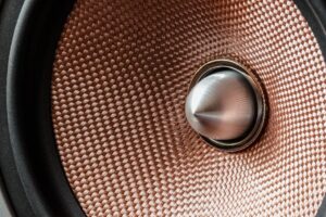 kinh nghiệm sửa loa - Detailed view of a metallic speaker cone with textured pattern and modern design.