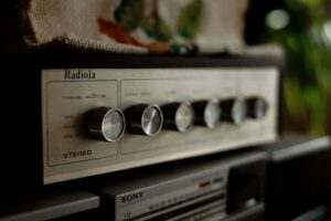 Sửa Amply Boston – Chuyên Nguồn, Sò, Echo - Close-up photo of a vintage Radiola stereo system, showcasing classic knobs and design.